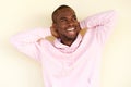 Carefree african american man laughing with hands behind head