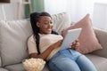 Carefree african american young lady using digital tablet Royalty Free Stock Photo