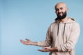 Carefree arab man pointing to right
