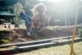 Carefree barefoot girl on swing in sun light