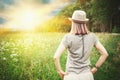 Carefree beautiful woman enjoying of sunlight in the meadow