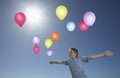 Carefree Boy In Midair With Colorful Balloons