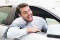 Carefree businessman sitting in drivers seat