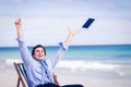 Carefree businessman throwing up his tablet in the air Royalty Free Stock Photo