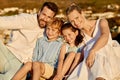 Carefree caucasian family watching the sunset together on the beach. Loving parents spending time with their son and Royalty Free Stock Photo