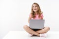 Carefree cheerful blond caucasian cute kid young sister sitting floor with laptop, laughing joyfully, studying online Royalty Free Stock Photo