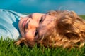 Carefree child laying on green summer grass. Happy child on green grass. Summer dream. Kid dreams on grass. Childhood Royalty Free Stock Photo