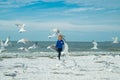 Carefree child. Little kid boy having fun on Miami beach. Happy cute child running near ocean hunting seagull birds on Royalty Free Stock Photo