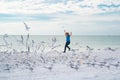 Carefree child. Child run on the seagulls on the beach, summer time. Cute little boy chasing birds near sea on summer