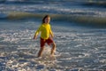Carefree child running on sea. Happy cute child running near ocean on warm summer day. A Cute little kid boy running and Royalty Free Stock Photo