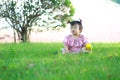 Carefree Chinese baby girl play a ball on the lawn Royalty Free Stock Photo