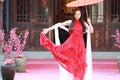 Carefree Chinese beauty is dancing in red dress Royalty Free Stock Photo