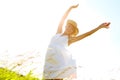 Carefree countryside moments. A carefree young woman standing with her arms outstretched in a meadow while smiling Royalty Free Stock Photo