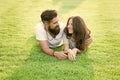 Carefree couple enjoying sunny day relaxing on green meadow, love from first sight concept Royalty Free Stock Photo