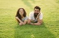 Carefree couple enjoying sunny day relaxing on green meadow, summer vacation concept Royalty Free Stock Photo