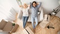 Carefree Couple Resting On Couch In New House, Top View Royalty Free Stock Photo