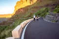 Carefree couple running on the mountain roadside