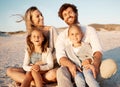 Carefree family bonding on the beach. Cheerful family enjoying a holiday by the sea. Caucasian parents bonding with Royalty Free Stock Photo