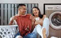 Carefree and funny couple doing laundry and relaxing together at home in the morning. Silly, goofy and playful lovers Royalty Free Stock Photo