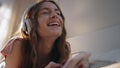 Carefree girl listening headphones music closeup. Smiling woman browsing mobile Royalty Free Stock Photo