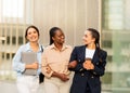 Carefree girlfriends walking by street after school, have conversation Royalty Free Stock Photo