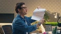 Carefree guys joking together office room closeup. Man throwing paper at partner