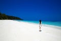 Carefree happy brunette woman walking on tropical beach, exotic Royalty Free Stock Photo