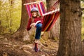 Carefree happy woman lying on hammock enjoying harmony with nature. Freedom. Enjoyment. Relaxing in forest.