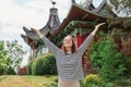 Carefree happy woman in spring or summer park raising arms with happiness, caucasian girl relaxing and enjoying life on nature Royalty Free Stock Photo