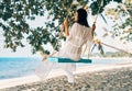 Carefree happy woman on swing on beautiful paradises beach Royalty Free Stock Photo