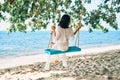 Carefree happy woman on swing on beautiful paradises beach Royalty Free Stock Photo