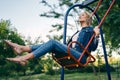 Carefree happy woman on swing outdoors Royalty Free Stock Photo