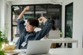 A carefree and happy Asian businessman is leaning back in his chair and stretching his arms Royalty Free Stock Photo