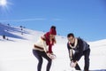 Carefree happy young couple having fun together in snow. Royalty Free Stock Photo