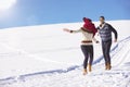 Carefree happy young couple having fun together in snow. Royalty Free Stock Photo