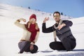 Carefree happy young couple having fun together in snow. Royalty Free Stock Photo