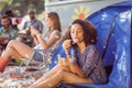 Carefree hipster blowing bubbles in tent