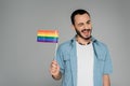 Carefree homosexual man holding lgbt flag