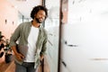 Carefree inspired african-american male employee standing in modern office space
