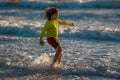 Carefree kid running on sea. Happy cute child running near ocean on warm summer day. A Cute little kid boy running and Royalty Free Stock Photo