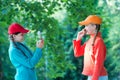 Carefree kids posing outdoor for photo. Positive models. Casual hipsters outfit. portrait of happy sisters with