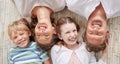 Carefree loving parents from above relaxing with their cute little laughing son and daughter. Happy caucasian family of Royalty Free Stock Photo