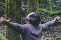 Carefree man with outstretched arms standing in the woods.Relaxed and meditating. Happiness and serene interior balance lifestyle