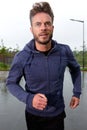 Carefree middle aged runner in rain