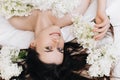 Carefree morning. Close up portrait of cheerful young smiling woman 20s old years relaxing in cozy white bed at home, positive