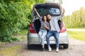 Carefree multiracial couple having break while car trip Royalty Free Stock Photo