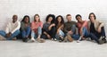 Carefree multiracial students chilling together on floor Royalty Free Stock Photo