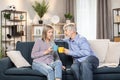 Carefree pensioners enjoying coffee and talking at home