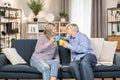Carefree pensioners enjoying coffee and talking at home