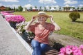 Happy senior woman in straw hat walking in park at sunny day, age beauty, baby boomer generation Royalty Free Stock Photo